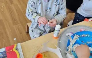 nursery child making a crown