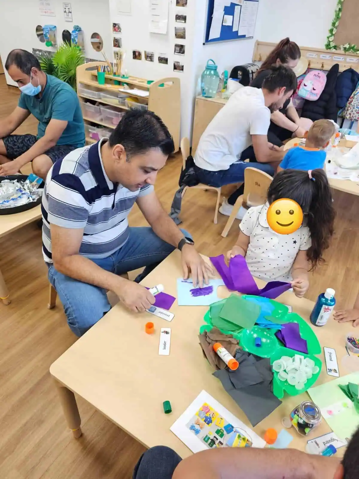 dad and children doing arts and crafts