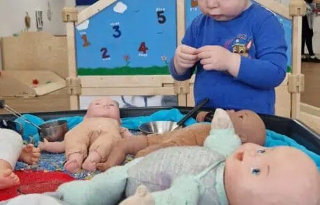 nursery child playing with dolls nursery child playing with dolls