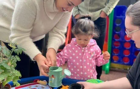 Families planting seeds at our nursery
