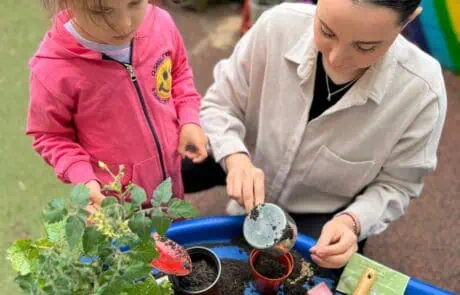 Nursery child planting seeds with staff