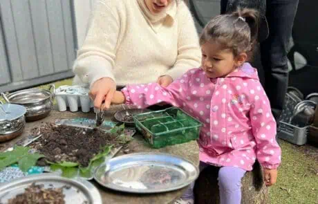 Parent and child planting seeds
